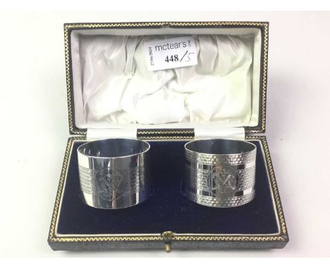 GROUP OF SILVER NAPKIN RINGS, including a pair of George V examples with engine turned decoration, along with two other silve
