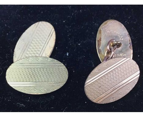 PAIR OF NINE CARAT GOLD AND SILVER CUFFLINKS, each panel with engine turned decorationQty: 10g