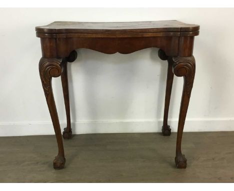 GEORGIAN MAHOGANY TURNOVER CARD TABLE, with carved legs on ball and claw feet75cm high, 76cm wide
