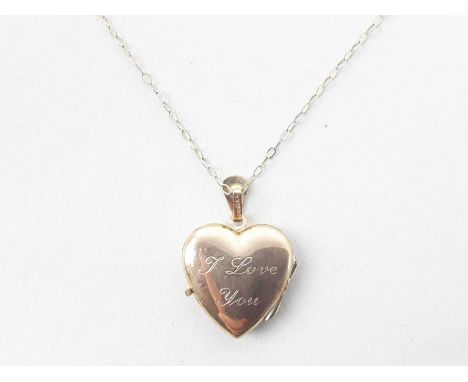 HEART SHAPED LOCKET ON CHAIN, IN NINE CARAT GOLD the locked engraved to one side with foliate designs and inscribed I love yo