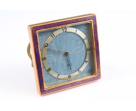 A Swiss 8-day Brass and Enamel Strut Clock. The clock with silvered numeric chapter ring set with on a pale blue moire silk g