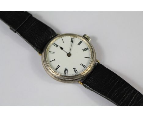 A Gentleman's Continental Antique Silver Wrist Watch. The watch having a white enamel face and Roman dial, approx 25mm diamet