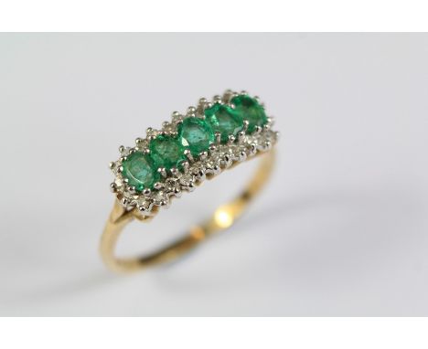 A Ladies 9ct Yellow Gold Emerald and Diamond Ring. The ring set five emeralds approx 4 x 3 mm, 25 pts of 8 cut dias, size R, 