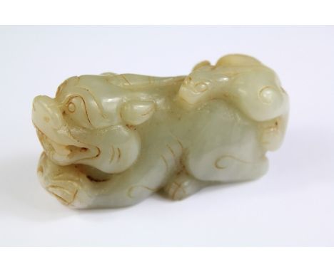 A Chinese Jade Foo Dog. The dog clasping a ball, approx 8 x 5 cms.