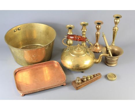 Miscellaneous Vintage Brass. This lot includes; a brass pestle and mortar, two pairs of candlesticks, a single candle stick a