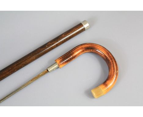 An Edwardian Sword Stick. The sword stick with turned handle and horn finial, fullered blade, approx 70 cms length.