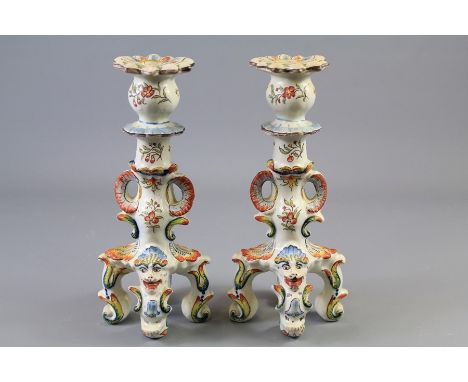 A Pair of Italian Majolica Earthenware Candlesticks. The candlesticks painted in typical pallet depicting a mask with horns, 