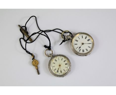 Two Victorian Continental Silver Pocket Watches. The watches with floral engraved cases, white enamel faces and Roman numeral