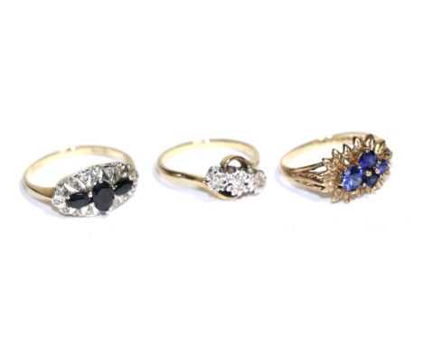 A diamond three stone twist ring, a 9 carat gold gemset ring and a sapphire and diamond ring (3) Twist ring - FInger size K1/