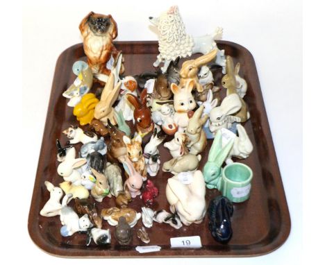 A large collection of miniature ceramic rabbits, including Wade, Goebel and Sylvac examples with other items including Beswic