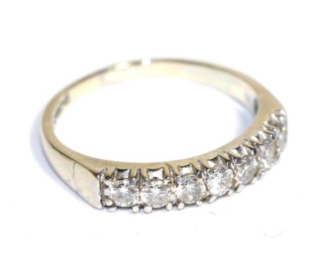 An 18 carat white gold diamond half hoop ring, total estimated diamond weight 0.50 carat approximately, finger size OThe ring