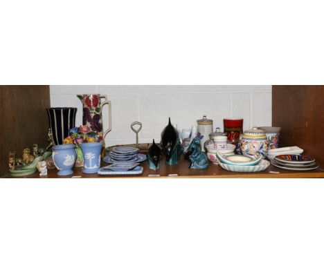 A shelf of 20th ceramics including Wade, Poole and Wedgwood