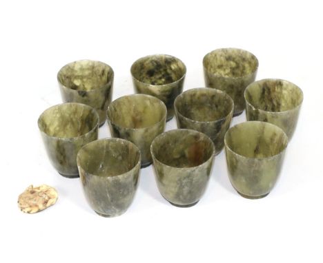 A Japanese Meiji period netsuke carved as monkeys, indistinctly signed; together with set of twelve jade type beakers 