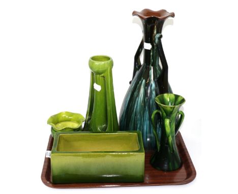 A Linthorpe pottery twin-handled vase, shape no. 2078, three pieces of green glazed Bretby and a green glazed tri-handled vas