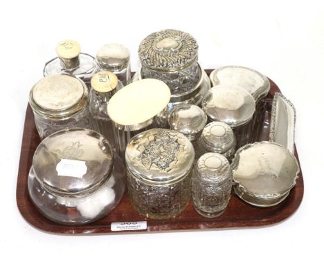 A group of silver topped dressing table jars, three early 20th century ivory topped examples and two silver ring boxes