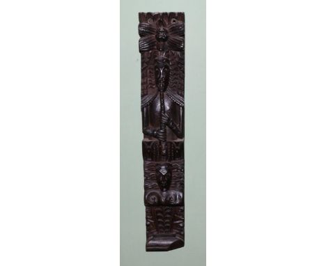 A carved oak Term figure, 17th century, as a musician playing pipes over a mask and scroll, 60.5cm by 11cm
