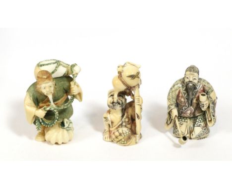 A Japanese Meiji period ivory netsuke of a water collector inset with three glass cabochons, signed Gyakushu in coral reserve