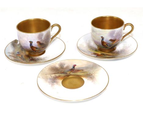 A pair of Royal Worcester porcelain coffee cups and three saucers painted by James Stinton, 1923, with pheasants in landscape