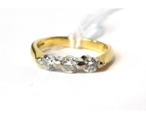 An 18 carat gold three stone diamond ring, 0.45 carat approx Finger size K, 3.45g gross.