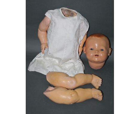 A German Heinrich Handwerck bisque head doll, having sleep eyes, open mouth and two teeth, composition body, and measuring  5