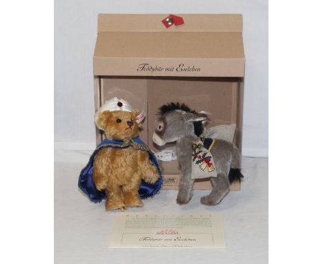 A Steiff teddy bear set, " Teddy bear with little donkey", limited edition 558 of 3000, the bear wears a midnight blue velvet