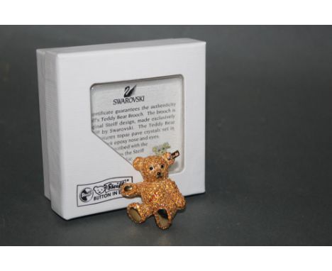 A Steiff gold coloured teddy bear brooch, made exclusively for Steiff by Swarovski, having a topaz pave crystal adorned body,