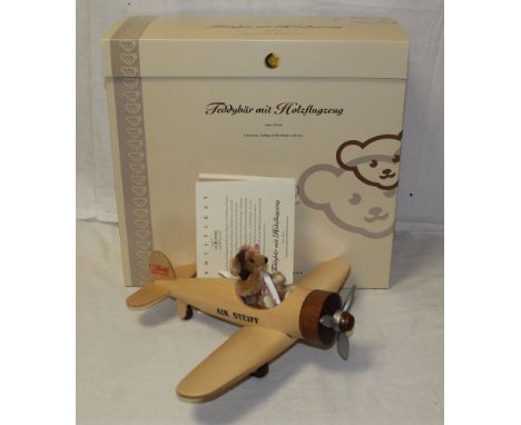 A Steiff "Teddy Bear with Wooden Airplane", limited edition 879 of 2005, having a cinnamon mohair covered body, measuring 12 