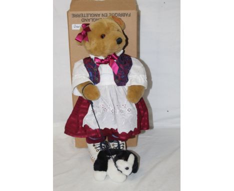 A Lakeland Bears teddy bear, titled "Charlotte", having a light brown mohair covered body, laced white dress, and with pet do