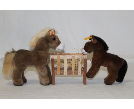 A Steiff "Cosy Ferdy", 097522, 18 cm tall, a Steiff Racy, 052552, 14 cm tall, a wooden slatted hay trough, and a Steiff Cosy 