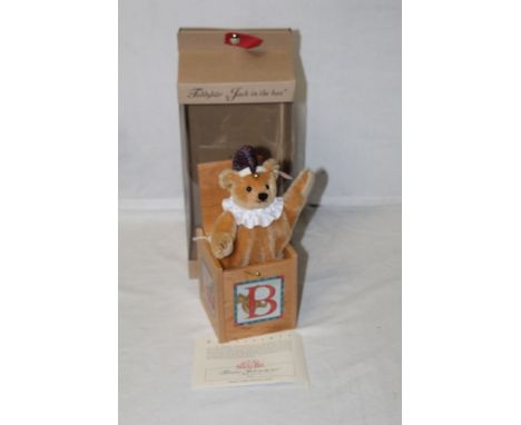 A Steiff teddy bear "Jack in the Box", limited edition 1565 of 3000,  sitting within a crafted and decorated wooden box, with