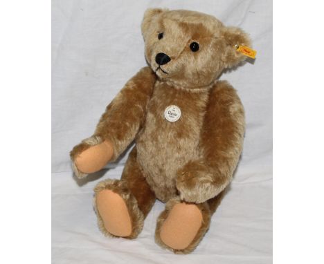 A Steiff Classic 1906 replica teddy bear, having a beige mohair covered body, with felt paw pads, a working growler mechanism