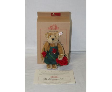 A Steiff teddy bear, "The Gardening Bear", limited edition 290 of 4000, having a blonde mohair covered body, wearing a green 