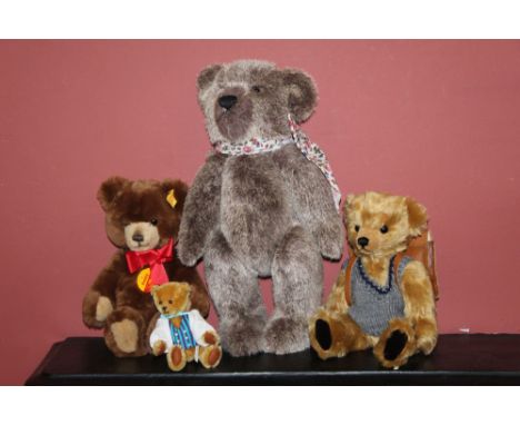 A group of three teddy bears, comprising a Big Softies teddy bear with grey-brown mohair covered body, wearing a floral bow t