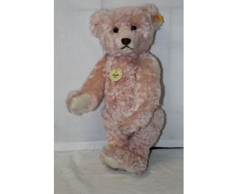 A Steiff Classic 1907 replica teddy bear, having a rose mohair covered body, a working growler mechanism and circular paper t