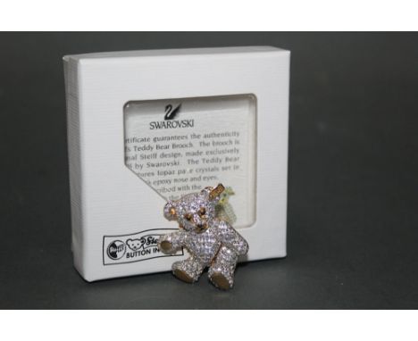 A Steiff teddy bear gold coloured brooch, made exclusively for Steiff by Swarovski, having a clear crystal adorned body, with