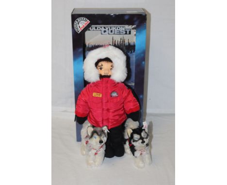 A Steiff Yukon Quest "Musher doll", limited edition 1999 of 3000, comprising a Musher and two huskies, all displayed within t