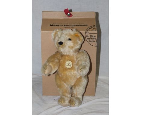 A Steiff Classic 1951 replica teddy bear, having a blonde mohair covered body, a working squeaker mechanism, measuring 30cm t