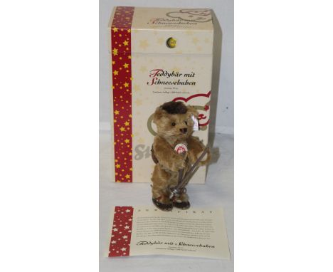 A Steiff teddy bear, "Teddy bear with snow shoes", limited edition 709 of 1500, having a brass mohair covered body, holding o