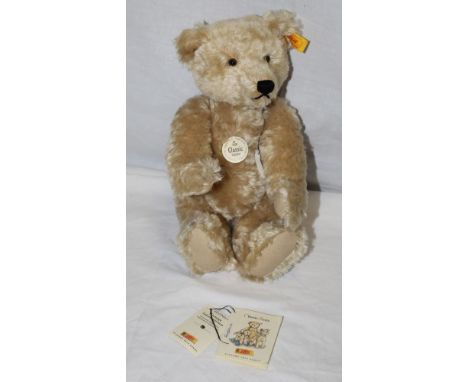 A Steiff Classic 1920 replica teddy bear, yellow label and button attached to its ear, having a blonde mohair covered body, w