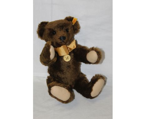 A Steiff Classic replica teddy bear, "Classic 1909", having a brown mohair covered body, wearing a mustard coloured bow tie, 