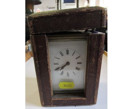 A brass cased carriage clock in travel caseCondition Report:  The clock winds but doesn't tick, the balance wheel does move w