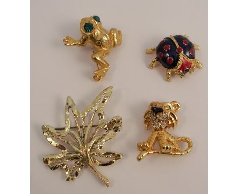 A paste and enamel comical lion brooch, together with a ladybird brooch, a paste set frog brooch, and a Hollywood leaf brooch