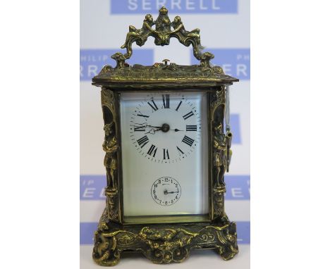 A reproduction brass carriage clock, the case decorated with figures and scrolls, height including handle 8ins