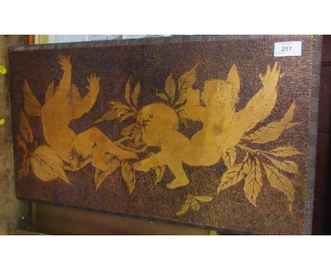 A pokerwork panel of cherubs and fruit, 14ins x 24ins