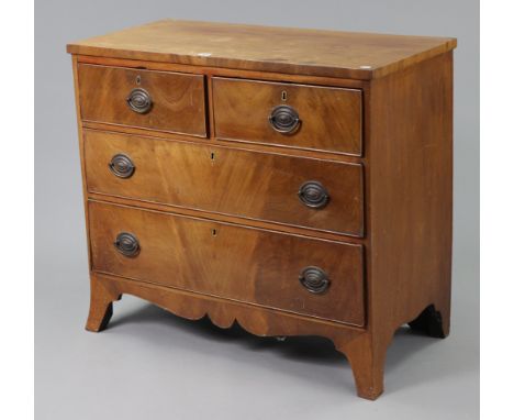 A Georgian mahogany small chest, fitted two short &amp; two long graduated drawers with brass swing handles, &amp; on ogee br