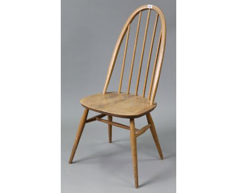 An Ercol light elm spindle-back dining chair with hard seat, &amp; on round tapered legs with spindle stretchers.