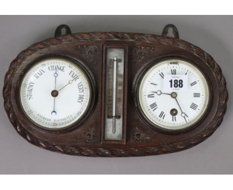 An early 20th century barometer/thermometer timepiece, mounted on a carved oak plaque, 12” wide x 6½” high.