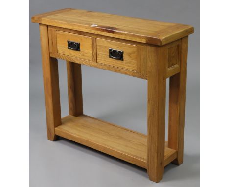 A light oak side table, fitted frieze drawer &amp; on square legs with open undertier, 35¾” wide x 32” high x 12” deep.