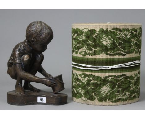 A bronzed composition ornament in the form of a kneeling boy holding a bucket, 11¾” high, signed &amp; dated "V. Marston 93";