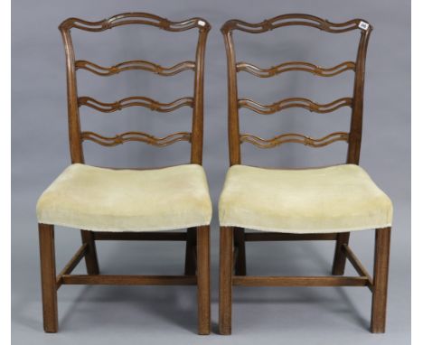 Two Chippendale-style mahogany dining chairs, each with shaped &amp; pierced back, padded drop-in seat, &amp; on square legs;